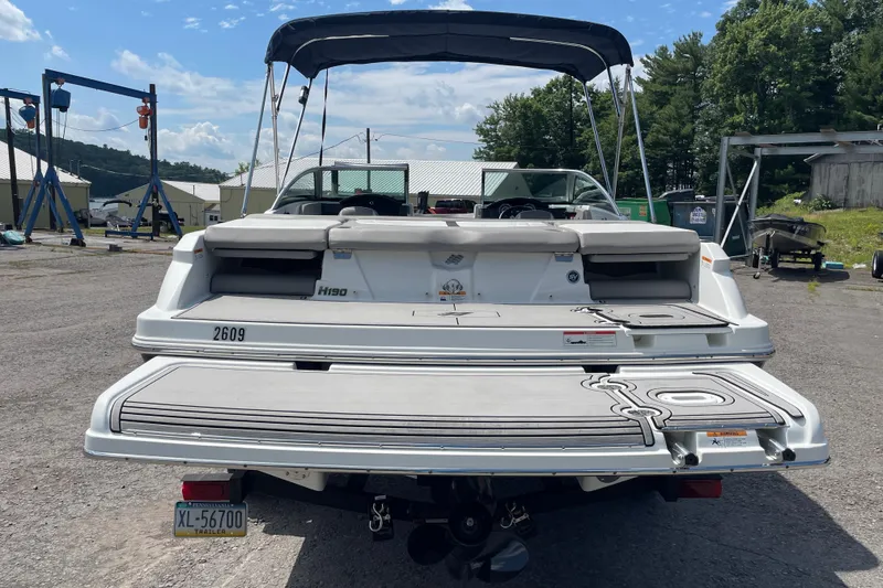 Slide: The Image of 2020 Four Winns H190 boat with swim platform, parked outdoors under a clear sky. - 8