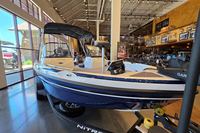 Slide: The Image of 2026 Nitro ZV19 Sport Pro boat displayed in a showroom with modern interior design. - 2