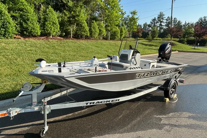 Slide: The Image of 2026 Tracker Bass Tracker Classic CC boat on trailer, parked outdoors. - 2