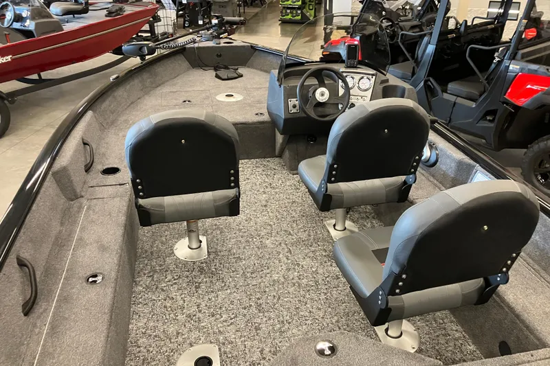 Slide: The Image of 2026 Tracker Pro Guide V-16 SC boat interior with seating and steering console. - 2