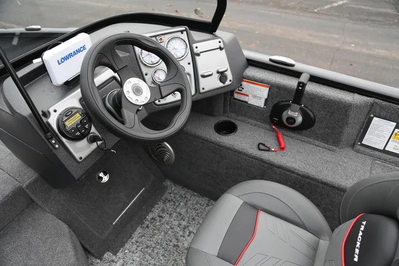 Slide: The Image of 2026 Tracker Pro Guide V-175 WT boat interior with steering wheel and control panel. - 5