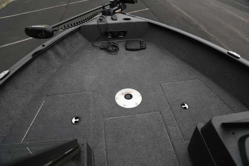 Slide: The Image of 2026 Tracker Pro Guide V-175 WT boat interior with carpeted deck and trolling motor. - 2