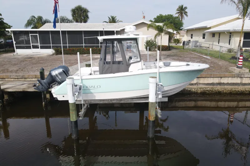 Slide: The Image of 2021 Robalo R230 Center Console boat docked near waterfront homes. - 7