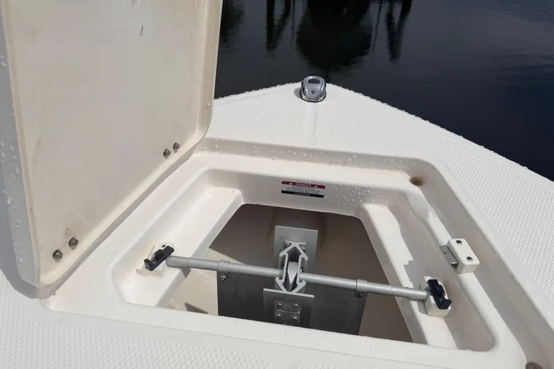 Slide: The Image of Open anchor compartment on 2021 Robalo R230 Center Console boat. - 26
