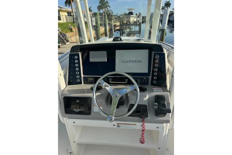 Slide: The Image of 2021 Robalo R230 Center Console boat dashboard with Garmin navigation system. - 13