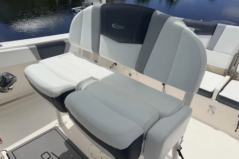 Slide: The Image of 2021 Robalo R230 Center Console boat seating, featuring comfortable, stylish upholstery by the water. - 27