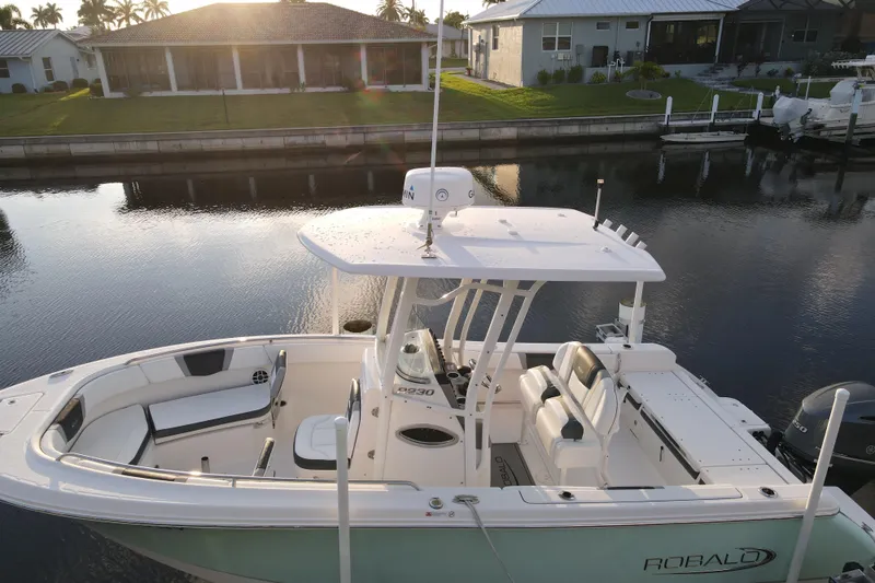 Slide: The Image of 2021 Robalo R230 Center Console boat docked by waterfront homes. - 4