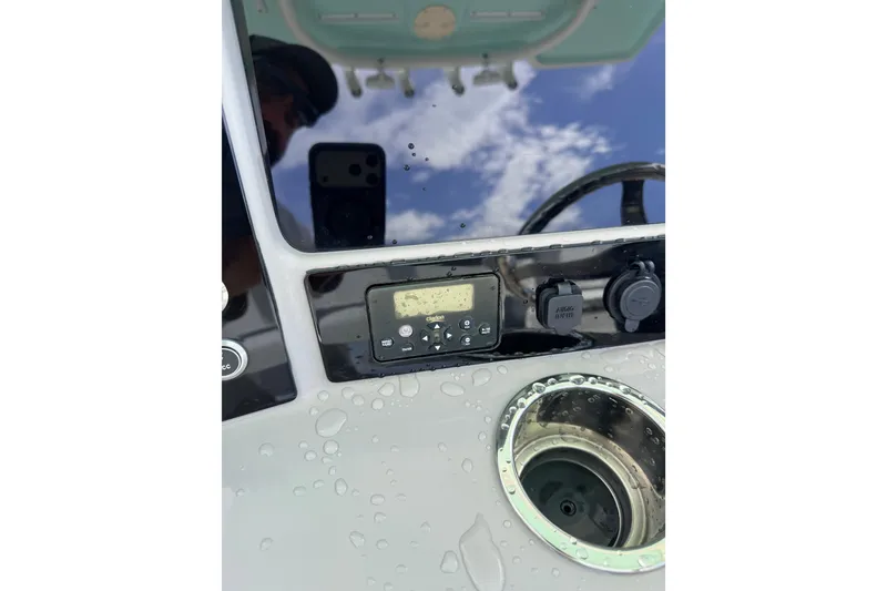 Slide: The Image of 2021 Robalo R230 Center Console dashboard with controls and cup holder. - 16