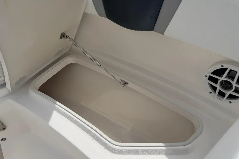 Slide: The Image of Open storage compartment on 2021 Robalo R230 Center Console boat interior. - 24