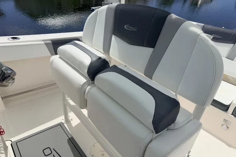 Slide: The Image of 2021 Robalo R230 Center Console boat seating with white and gray upholstery. - 30