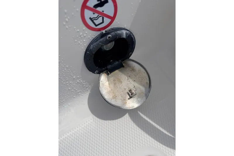 Slide: The Image of Open fuel cap on 2021 Robalo R230 Center Console boat with warning sticker. - 10