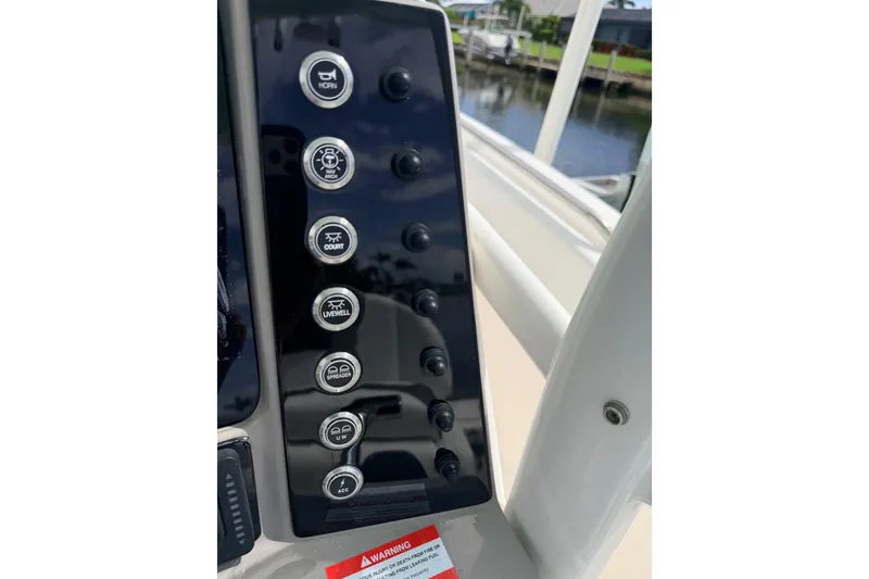 Slide: The Image of Control panel of 2021 Robalo R230 Center Console boat with labeled buttons. - 12