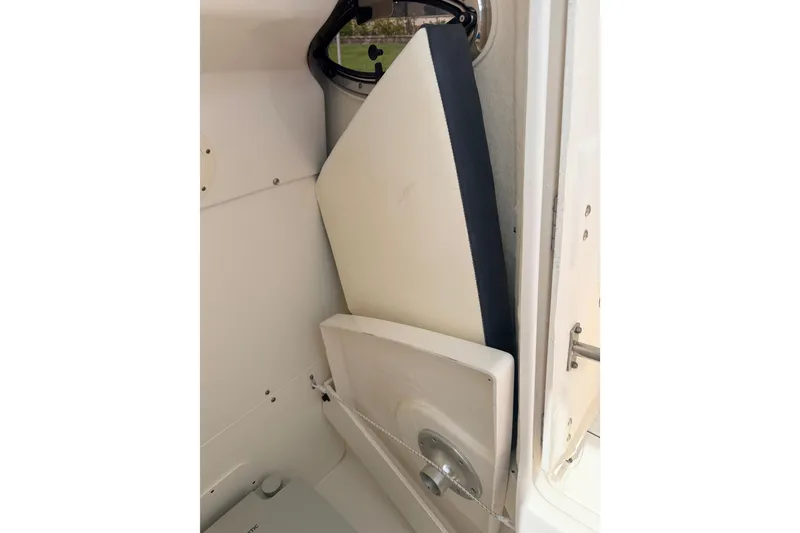 Slide: The Image of 2021 Robalo R230 Center Console interior storage compartment with cushion and hatch. - 20