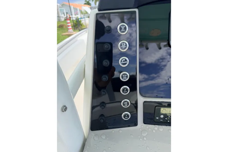 Slide: The Image of Control panel of 2021 Robalo R230 Center Console boat with various function buttons. - 11