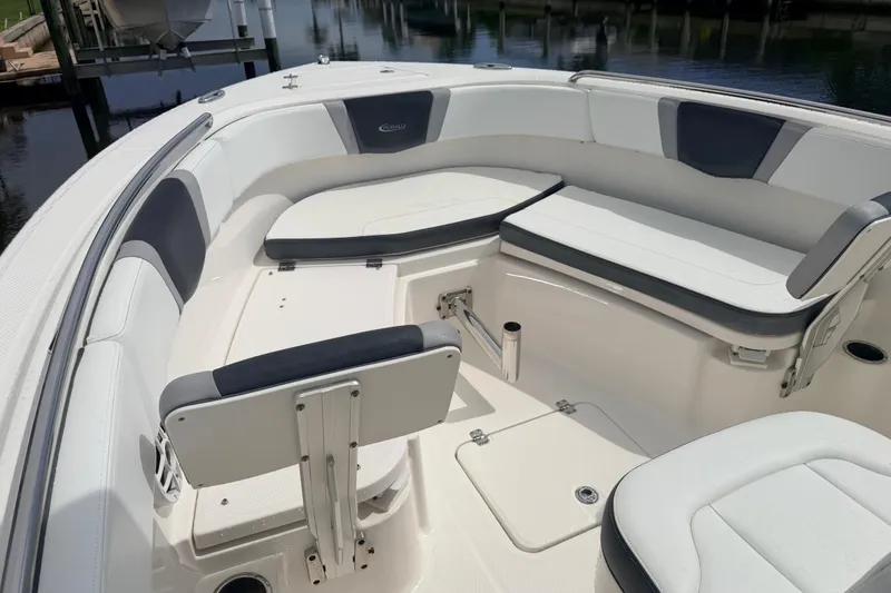 Slide: The Image of 2021 Robalo R230 Center Console boat interior with cushioned seating and storage compartments. - 19