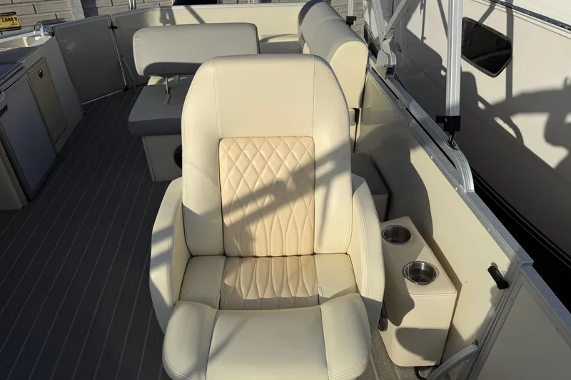 Slide: The Image of Luxurious seating on 2021 Lexington 521 5 Series boat with cup holders and elegant design. - 8