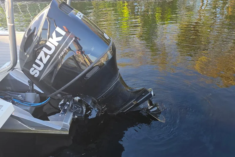 Slide: The Image of Outboard motor on a 2021 Lexington 521 5 series boat in water. - 13