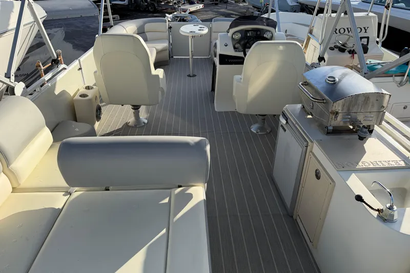 Slide: The Image of Luxurious 2021 Lexington 521 5 Series boat interior with seating and grill. - 10