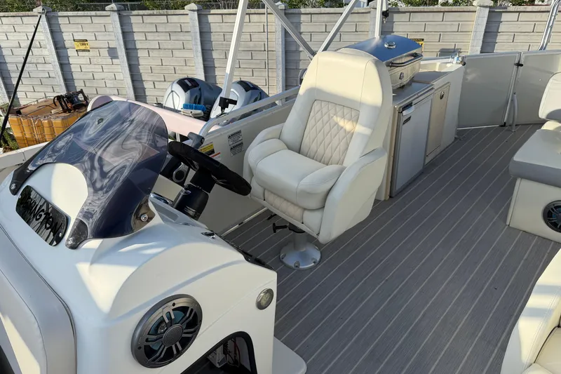 Slide: The Image of Luxurious 2021 Lexington 521 5 Series boat interior with helm and seating. - 7