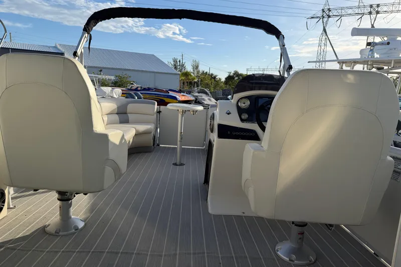 Slide: The Image of Interior of a 2021 Lexington 521 5 Series boat with plush seating and steering console. - 5