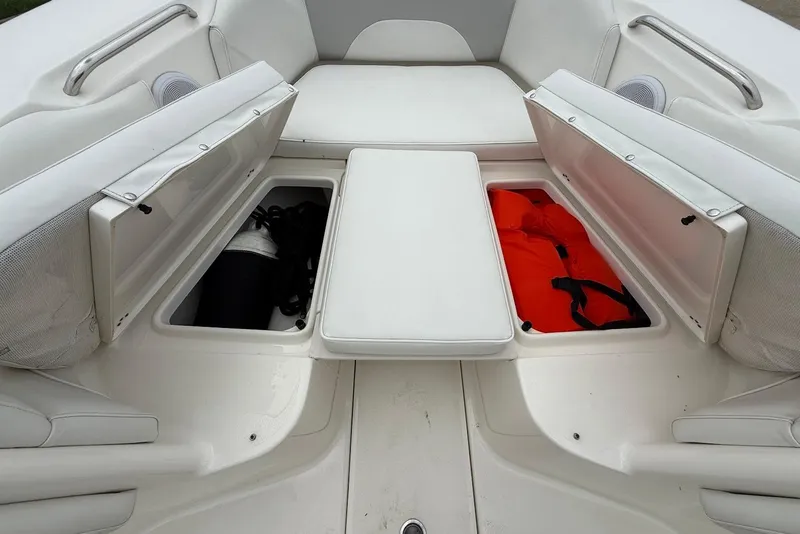 Slide: The Image of 2023 Key West 263 FS boat interior with open storage compartments and safety gear. - 25