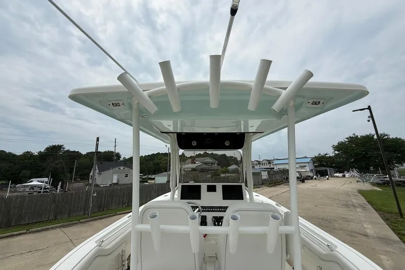 Slide: The Image of 2023 Key West 263 FS boat console with rod holders and electronics, docked outdoors. - 10