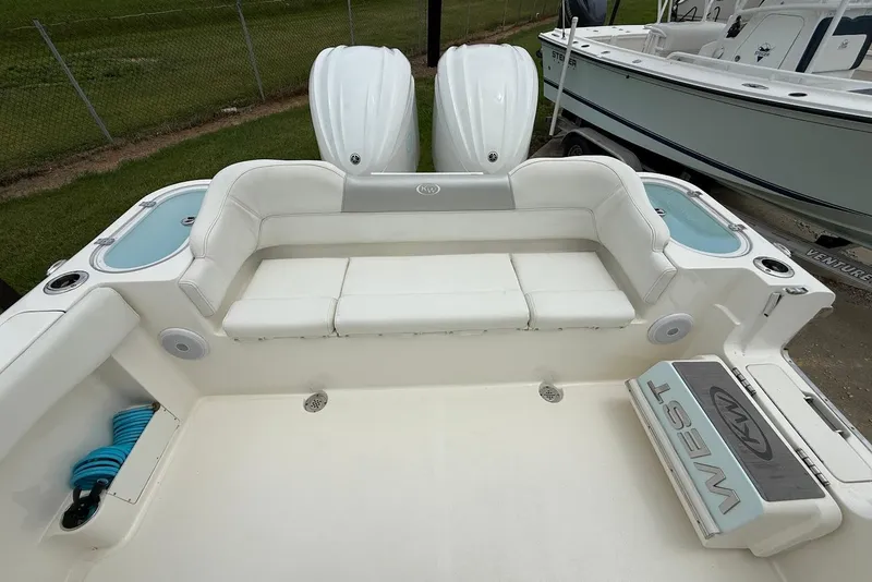 Slide: The Image of 2023 Key West 263 FS boat interior with white seating and twin engines. - 7