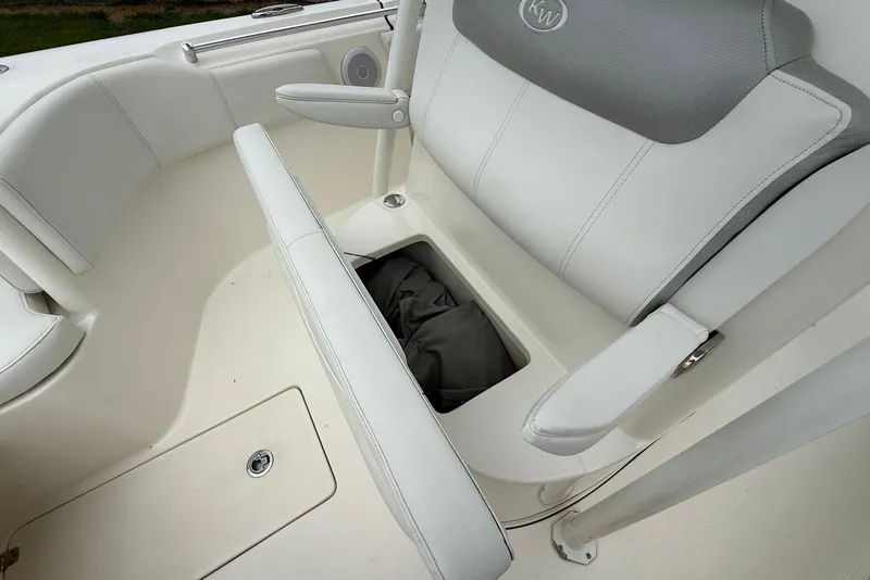 Slide: The Image of 2023 Key West 263 FS boat interior with white seating and storage compartment. - 22