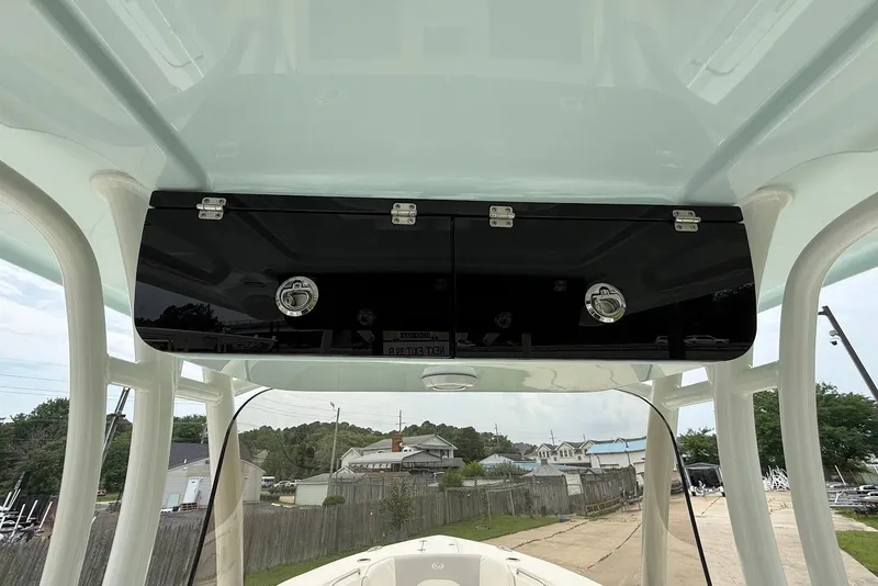 Slide: The Image of 2023 Key West 263 FS boat's overhead storage compartment with secure latches. - 16