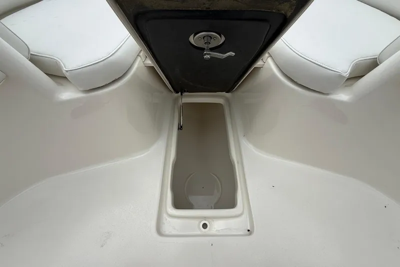 Slide: The Image of 2023 Key West 263 FS boat interior storage compartment with white seating. - 24