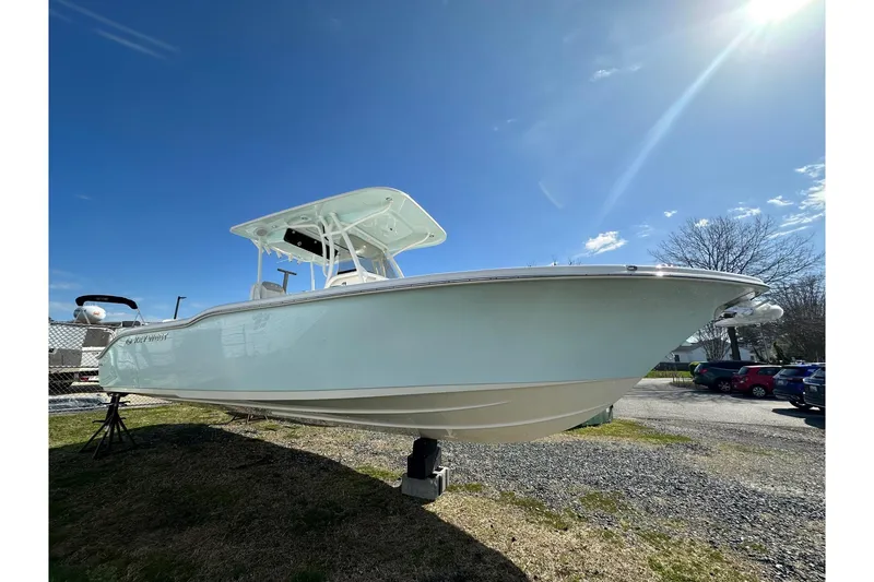 The Image of 2023 Key West 263 FS boat displayed outdoors under a clear blue sky. - 14