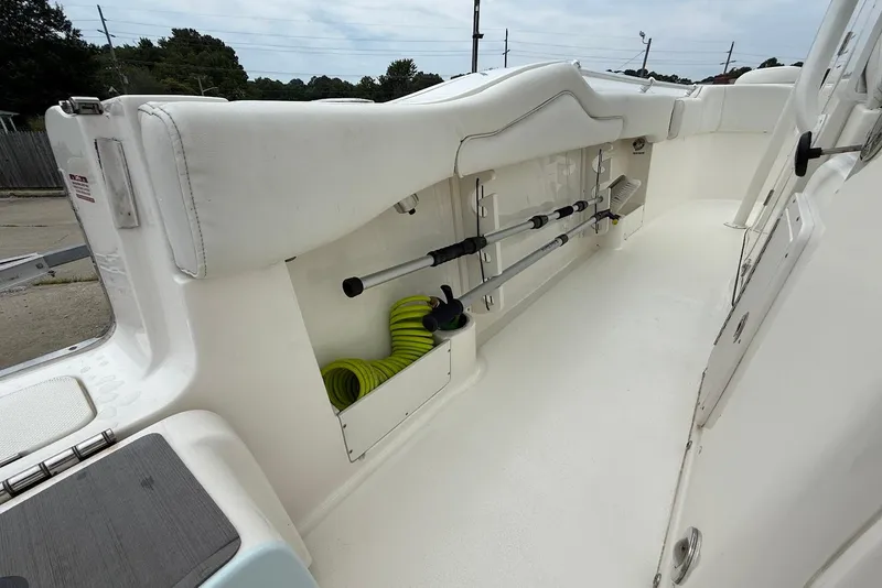 Slide: The Image of 2023 Key West 263 FS boat interior with rod holders and storage compartment. - 11