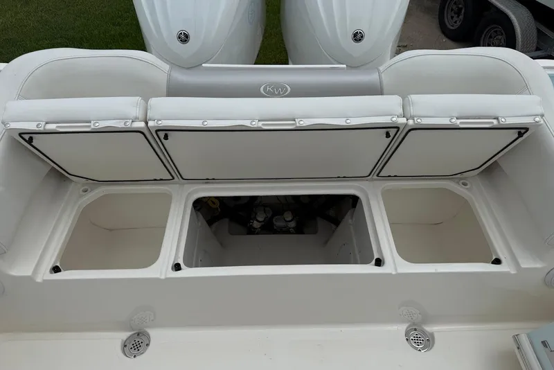Slide: The Image of 2023 Key West 263 FS boat with open storage compartments and Yamaha engines. - 8