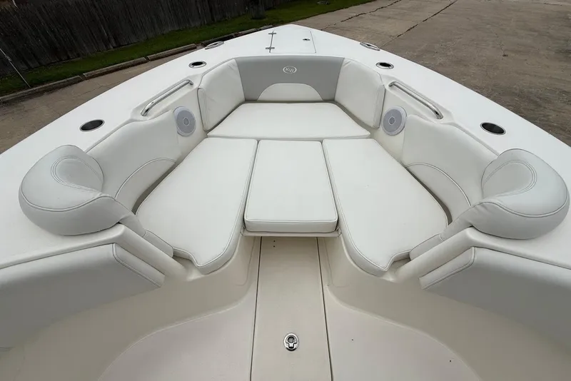 Slide: The Image of 2023 Key West 263 FS boat interior with white cushioned seating and cup holders. - 23