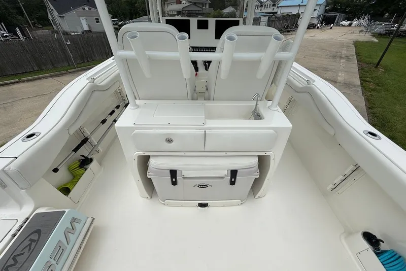 Slide: The Image of 2023 Key West 263 FS boat interior with seating, storage, and fishing rod holders. - 9