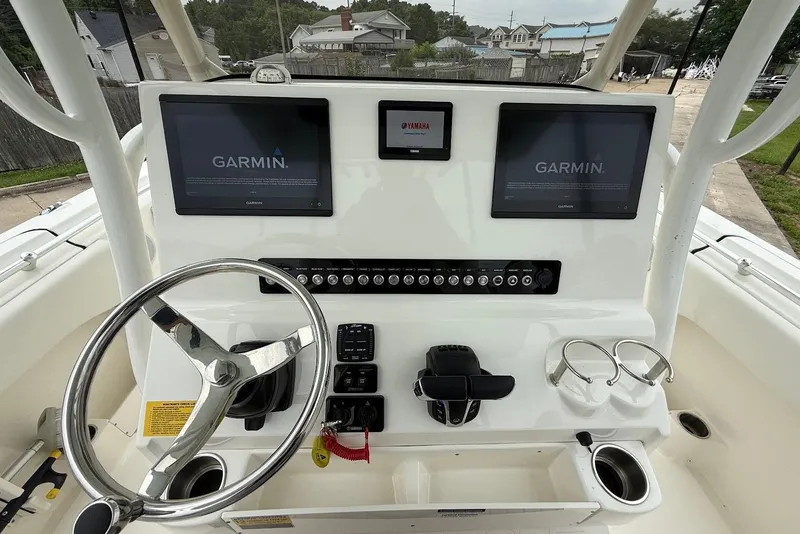 Slide: The Image of 2023 Key West 263 FS boat dashboard with Garmin displays and steering wheel. - 14