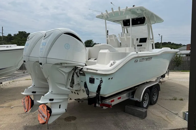 Slide: The Image of 2023 Key West 263 FS boat on trailer with dual Yamaha outboard engines. - 3