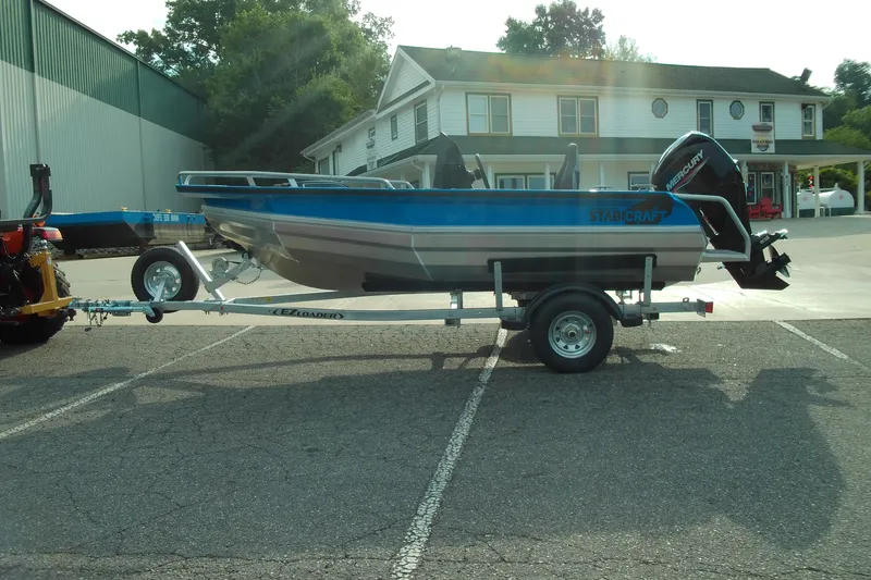Slide: The Image of 2025 Stabicraft 1450 Frontier boat on trailer in parking lot. - 2
