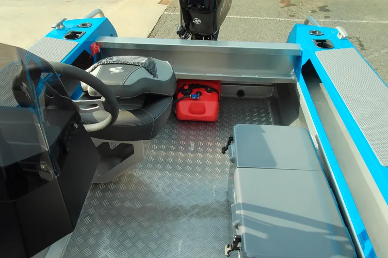Slide: The Image of Interior of 2025 Stabicraft 1450 Frontier boat with steering wheel and seating. - 9