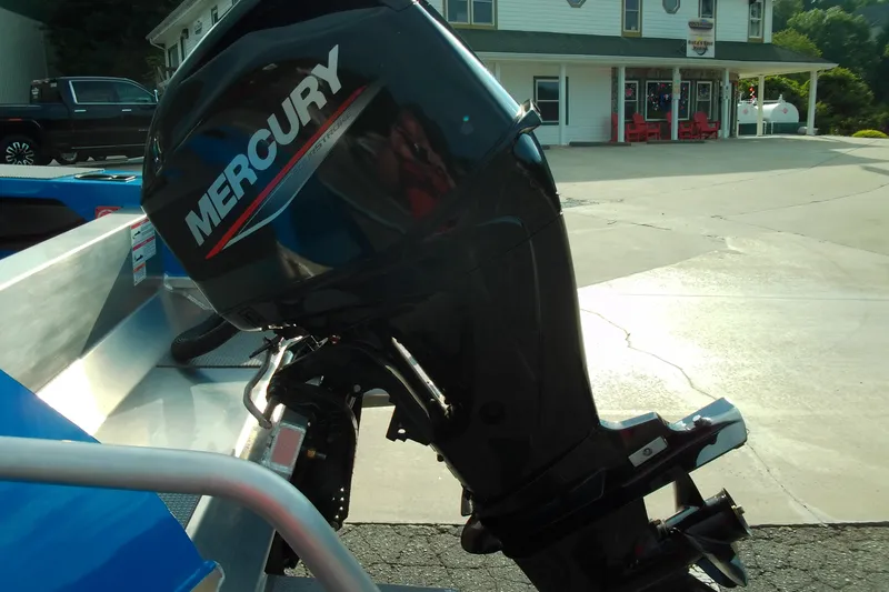 Slide: The Image of 2025 Stabicraft 1450 Frontier with Mercury outboard motor in a driveway setting. - 13