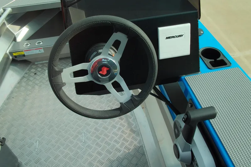 Slide: The Image of Steering wheel and controls of 2025 Stabicraft 1450 Frontier boat. - 5