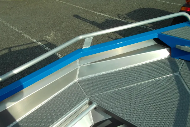 Slide: The Image of 2025 Stabicraft 1450 Frontier boat deck with blue trim and textured surface. - 11