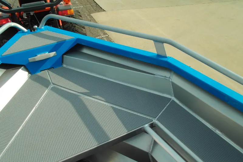 Slide: The Image of 2025 Stabicraft 1450 Frontier boat interior with blue accents and textured flooring. - 12