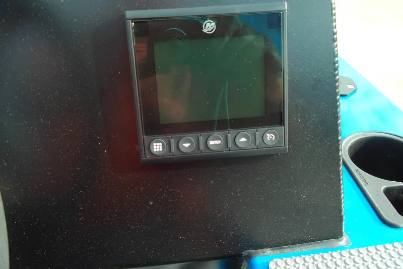 Slide: The Image of Control panel on 2025 Stabicraft 1450 Frontier boat dashboard, featuring navigation buttons. - 6