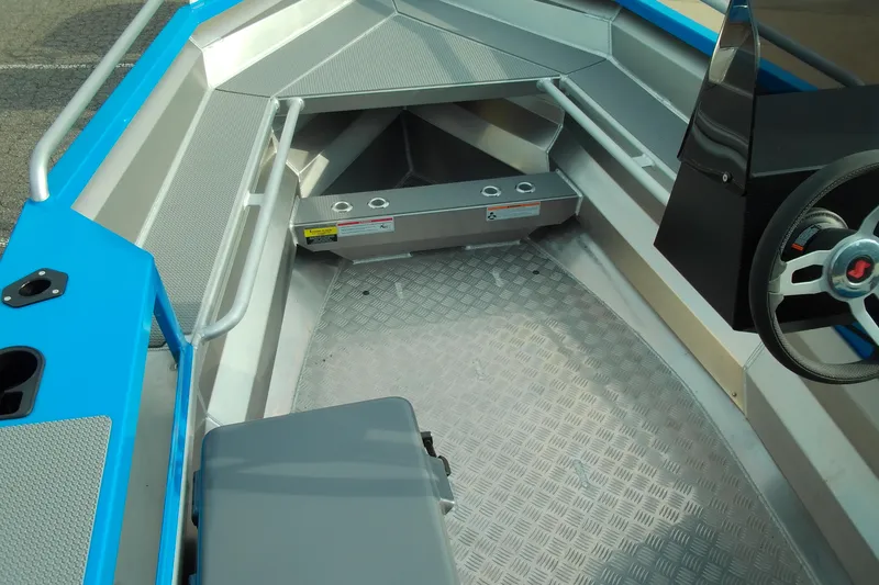 Slide: The Image of Interior view of 2025 Stabicraft 1450 Frontier boat, featuring steering wheel and seating. - 4