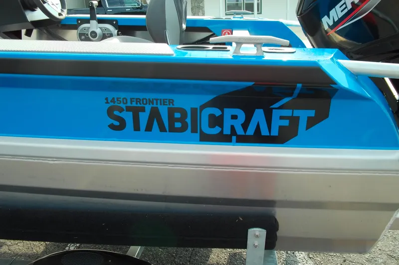 Slide: The Image of 2025 Stabicraft 1450 Frontier boat with blue and black branding. - 3