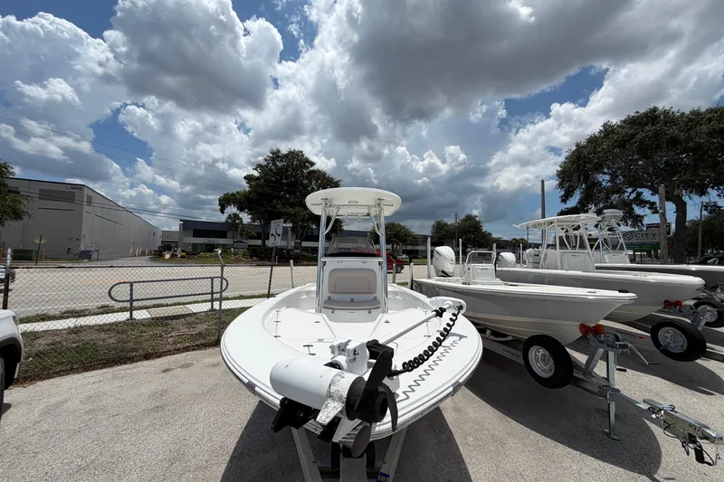 Slide: The Image of 2019 Sportsman Masters 227 Bay Boat on trailer under cloudy sky. - 1