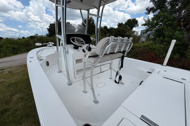 Slide: The Image of 2019 Sportsman Masters 227 Bay Boat with T-top and seating, parked on grass. - 13