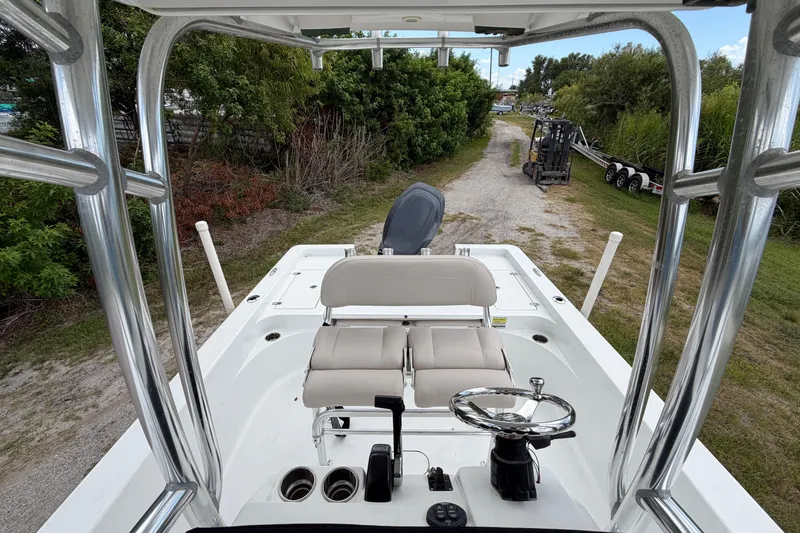 Slide: The Image of 2019 Sportsman Masters 227 Bay Boat interior with steering wheel and seating. - 5