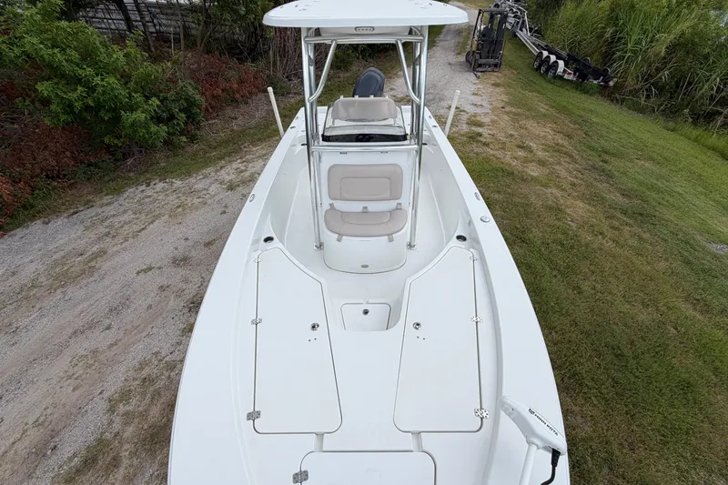 Slide: The Image of 2019 Sportsman Masters 227 Bay Boat on grassy terrain, showcasing spacious deck and seating. - 7
